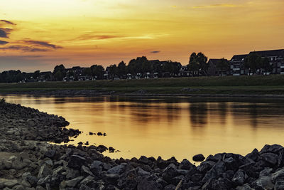 Scenic view of lake against sky during sunset