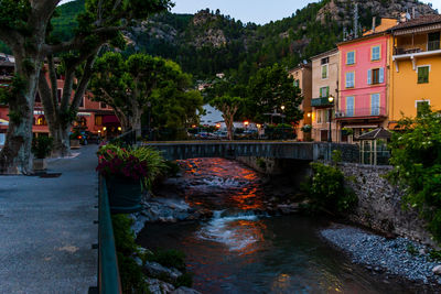 Bridge over river by buildings in city