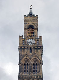 Low angle view of clock tower against sky