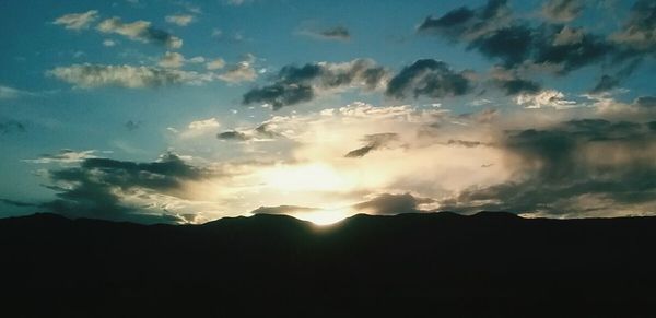 Silhouette mountains against sky during sunset