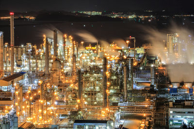 High angle view of illuminated buildings in city at night