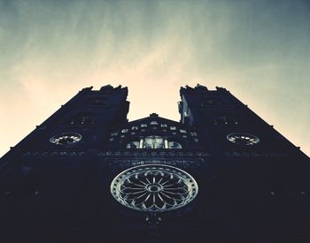 Low angle view of clock tower against sky