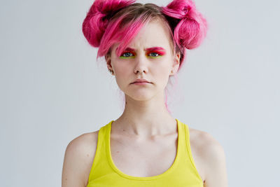 Portrait of young woman against white background