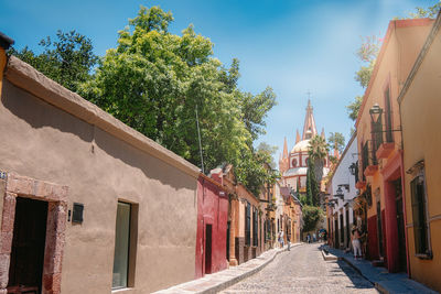 Street amidst buildings against sky