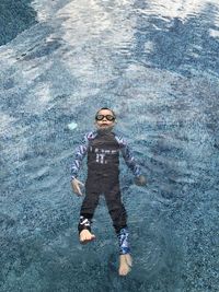 High angle view of boy swimming in pool