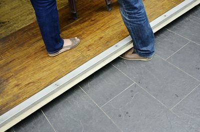 Low section of woman standing on tiled floor