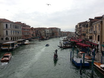 Boats in canal with buildings in background