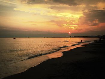 Scenic view of beach at sunset