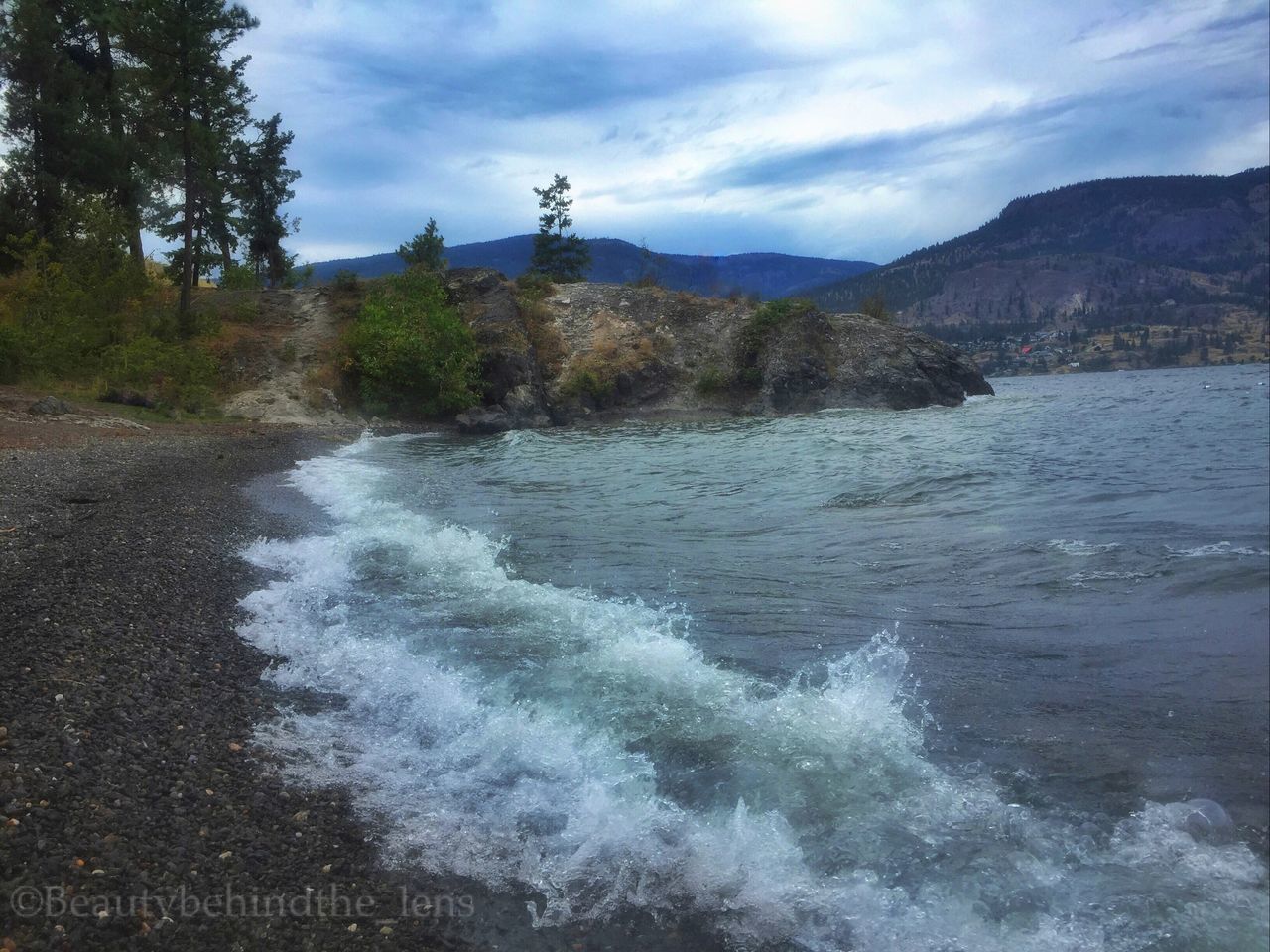 VIEW OF RIVER FLOWING THROUGH ROCKS