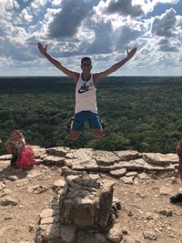 Full length of man jumping against sky