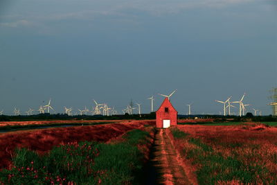 Traditional windmill on field against sky