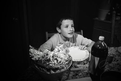 Portrait of boy sitting on table