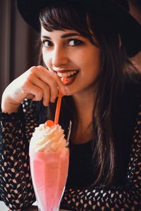 Close-up portrait of young woman having cold coffee