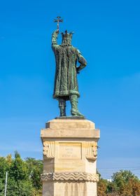 Low angle view of statue against blue sky