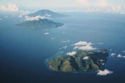 Aerial view of sea and mountains against sky