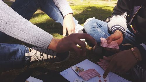 High angle view of people sitting on field