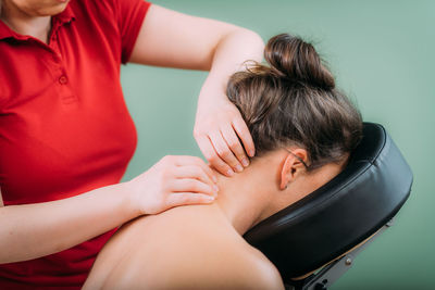 Chair massage. therapist massaging womans neck, stress and tension relief