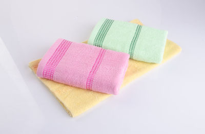 Close-up of folded towels on white background