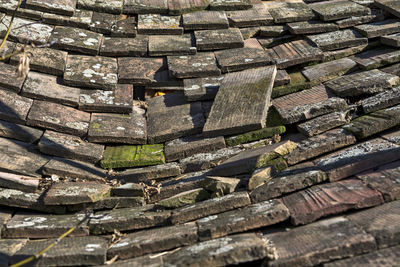 Old tile on the roof of the auxiliary building of the rural household.