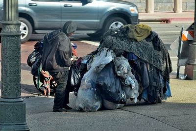 Sanitation worker picking garbage on street
