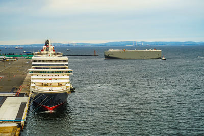 Ship sailing in sea against sky