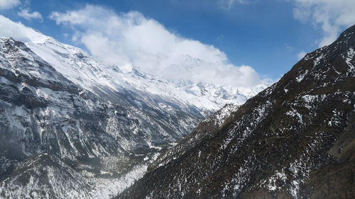 Scenic view of snowcapped mountains against sky