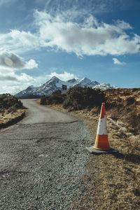 Road sign against sky