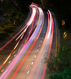 High angle view of light trails on road at night