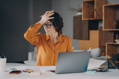 Young woman using laptop on table