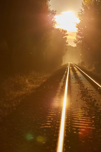 View of railroad tracks against sky during sunset