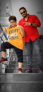 Low angle view of friends standing on street