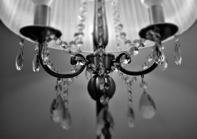 Close-up of crystal decoration hanging on electric lamp