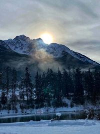 Scenic view of snow covered mountains against sky