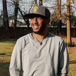 Portrait of smiling man standing against plants