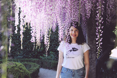 Portrait of smiling young woman standing outdoors