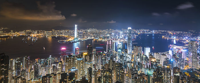 Illuminated cityscape against sky at night