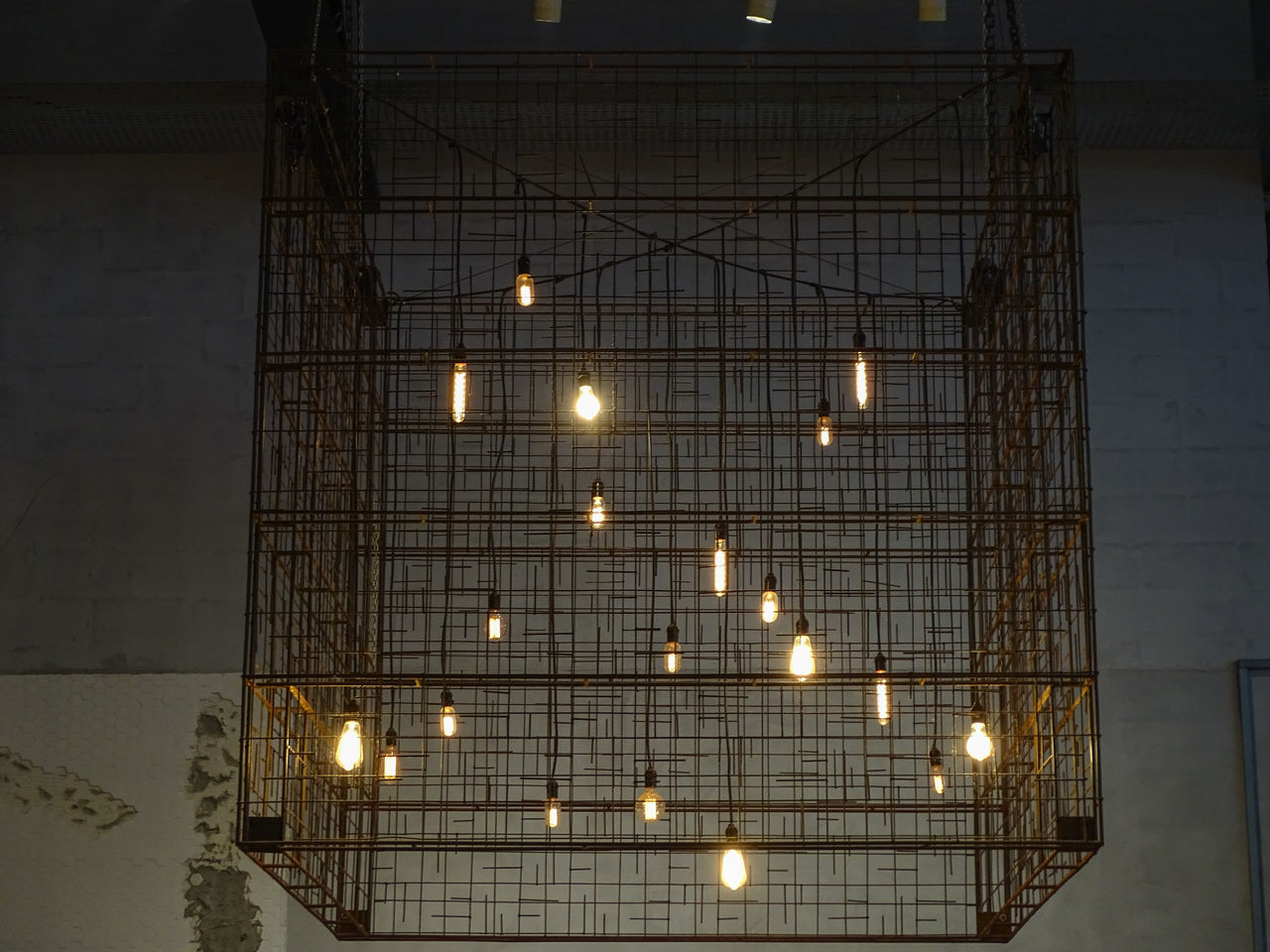 LOW ANGLE VIEW OF ILLUMINATED LIGHTS ON CEILING IN BUILDING