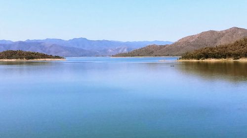 Scenic view of lake against blue sky