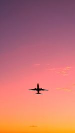 Silhouette airplane flying against clear sky