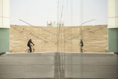 Man riding bicycle on urban street