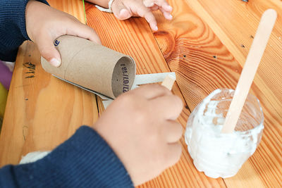 Midsection of woman holding ice cream on table