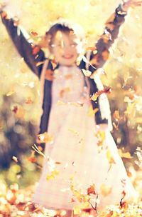 Midsection of woman standing by tree