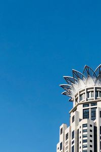 Low angle view of buildings against blue sky