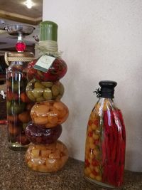 Close-up of glass jar on table against wall