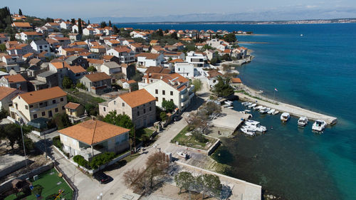 High angle view of townscape by sea