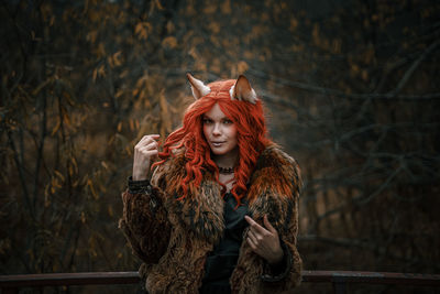 Portrait of young woman standing in winter