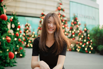 Portrait of a young woman with christmas tree