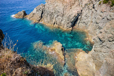 High angle view of rocks by sea