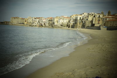 View of beach with city in background