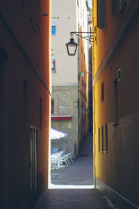 Empty alley amidst buildings in city